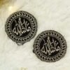 Close-up of circular black velvet Imam Zamin with silver Mashallah calligraphy and leaf border