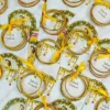 Traditional favor cards holding bangles with bride and groom illustration