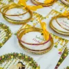Close-up of custom Mehndi bangle favor card with cultural artwork