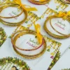 Colorful glass bangles attached to beautifully illustrated favor cards