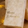 Couple names in gold calligraphy on floral bid boxes