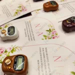 Close-up of digital tally counter on customized Nikkah favor card