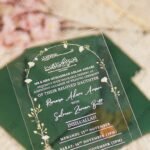 Green acrylic wedding invitation with Quranic calligraphy and gold floral arch