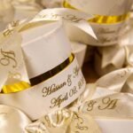 Close-up round cream Nikkah bid boxes with gold printed ribbon