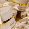 Name and date printed on cream ribbon for bid boxes