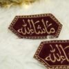Pair of hexagonal maroon and gold Mashallah Nikkah armbands on white background
