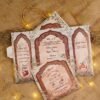 Traditional Mughal arch multi-fold wedding invitation in maroon and gold