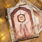 Close-up of traditional dholki and ghodi illustrations on wedding card