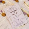 Bulk pastel yellow wedding invitations with dried purple flowers and wax seals