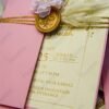 Pink wedding cards with pampas grass accents and pink baby's breath styling