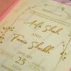Bulk pink wedding invitations with wax seals and floral embellishments
