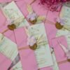 Close-up of gold wax seal with artificial flower and pampas grass accent
