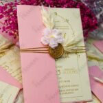 Pink wedding cards with pampas grass accents and pink baby's breath styling