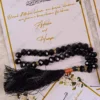 Multiple black pearl tasbeeh favor cards arranged beautifully