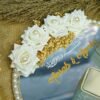 Detail of hand-placed white roses and dried golden flowers on a personalized nikkah ring tray