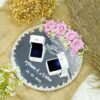 Full view of minimal pearl edition mirror engagement ring tray with white calligraphy and satin bow