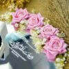 Close-up of artificial wild flowers and white satin ribbon bow on nikkah ring tray