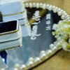 Close-up of pearl and rhinestone border detail on mirror engagement ring tray