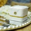 Close-up of 3D white rose cascade arrangement with baby's breath on a mirror ring tray