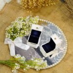 Minimalist mirror engagement ring plate with Quranic calligraphy, pearl border, and white satin bow