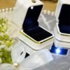 Close-up of white wildflower arrangement with satin ribbon bow on mirror ring tray
