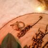 Top-down view of personalized wooden engagement ring tray with engraved names and date
