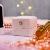Close-up top view of square engagement ring tray showing rose gold pearl border detail