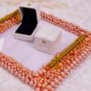 Front angle of square ring tray with gold handles and blush pink pearl frame design