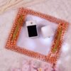 Full view of rose gold pearl frame engagement ring tray with pink flowers and ring boxes