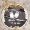 Detail of personalized white calligraphy names and date on mirror ring tray surface