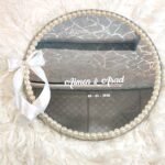 Minimalist mirror ring tray with pearl border, white satin bow, and Bismillah calligraphy with personalized names