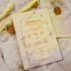 Minimalist white vellum wedding cards arranged with floral props