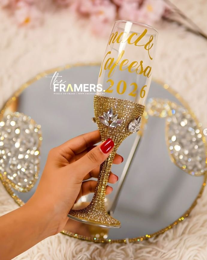 Gold rhinestone Doodh Pilai glass held in hand showing crystal crown detailing